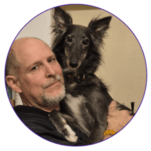 portrait de Daniel Charbonneau avec un Lévrier de Soie dans les bras